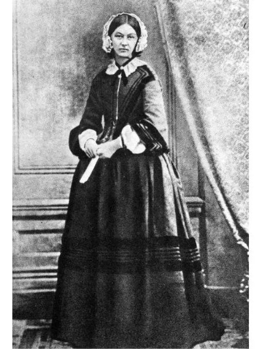 A black and white photograph of Florence Nightingale in her nurse's uniform