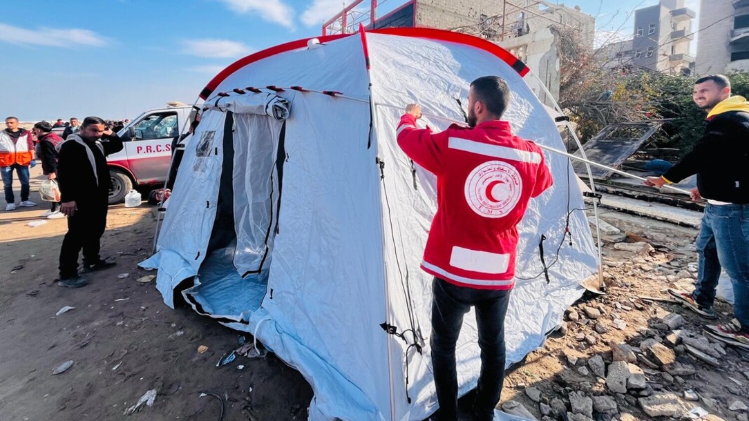 A Palestine Red Crescent Society worker helps to assemble a tent in North Gaza.