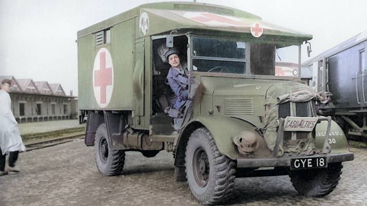 Women driving a green Red Cross ambulance