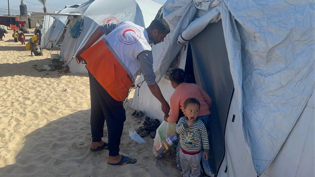 Palestine Red Crescent teams delivering aid to displaced families living in shelters in Gaza