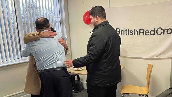 Ali, Chnoor and Ayub in the Refugee Support office in Leicester after being reunited.